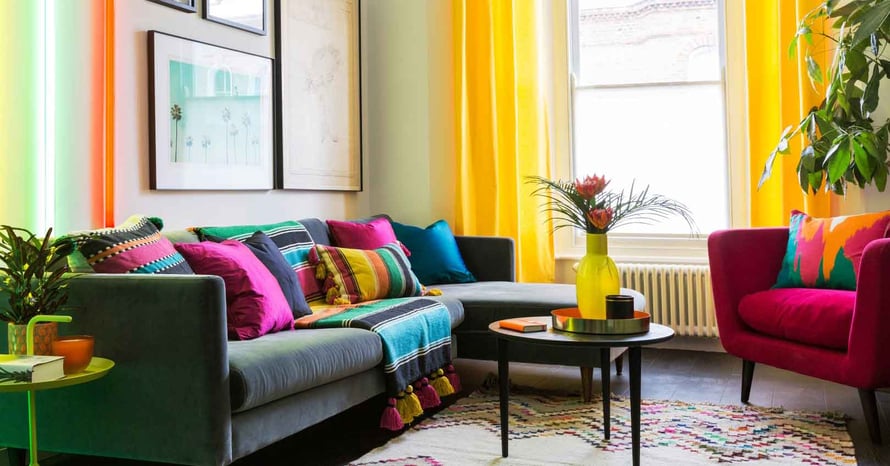 Bright-Coloured-Lounge-Room-Commerical-Interior-With-Yellow-Curtains-And-Pink-Cushions